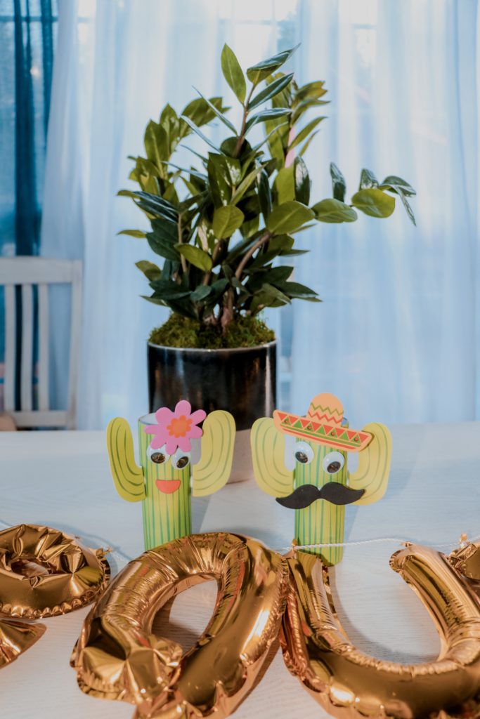 How To Throw A Mexican Party featured by top US life and style blog Nashville Wifestyles | How To Throw A Fiesta In Under An Hour & Under $200 - Nashville Wifestyles; Whether you’re prepping a birthday party, a Cinco de Mayo celebration, or a fiesta for Taco Tuesday like our family did, I’ve got tips, recipes and more! Outside, we decorated the table with Multi-colored Maracas, sombreros, decorative paper straws and DIY kids craft cacti. Sombreros decorados ideas can be a fun craft before the fiesta theme party. Click to read about how to make taco Tuesday recipes with ground beef & how to make kids fiesta birthday party decorations. 