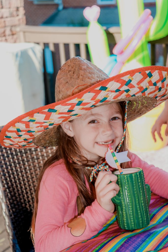 How To Throw A Mexican Party featured by top US life and style blog Nashville Wifestyles | How To Throw A Fiesta In Under An Hour & Under $200 - Nashville Wifestyles; Whether you’re prepping a birthday party, a Cinco de Mayo celebration, or a fiesta for Taco Tuesday like our family did, I’ve got tips, recipes and more! Outside, we decorated the table with Multi-colored Maracas, sombreros, decorative paper straws and DIY kids craft cacti. Sombreros decorados ideas can be a fun craft before the fiesta theme party. Click to read about how to make taco Tuesday recipes with ground beef & how to make kids fiesta birthday party decorations. 