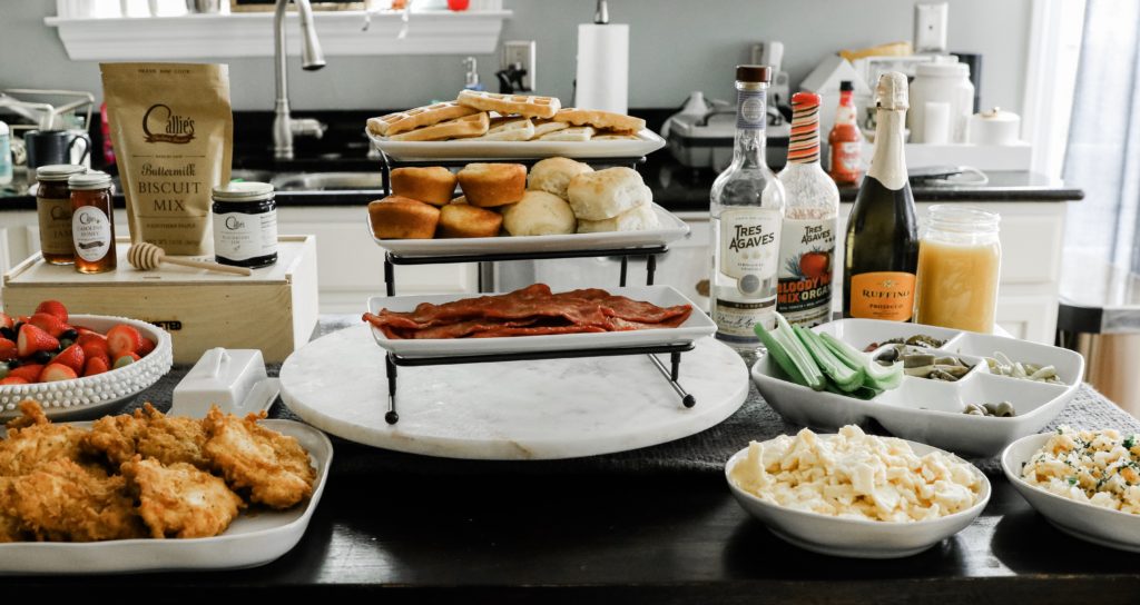 Southern Style Brunch Ideas That Pulls Out All the Stops - Nashville Wifestyles; I had family in town last weekend so I decided to throw a brunch together for my family and friends before watching college football that Saturday. There's nothing more tasty than a family weekend brunch made up of tasty brunch recipes. Click to read how to throw a Sunday brunch at home on Nashville Wifestyles! For the waffles, I used the Kodiak protein waffle mix. We also had turkey bacon, fresh cut fruit salad, Nashville fried chicken and more for our brunch meal. | Southern Style Brunch Ideas That Pulls Out All the Stops by popular Nashville lifestyle blog, Nashville Wifestyles: image of fried chicken, waffles, bacon, a bowl full of fruit, and a Biscuit Box.