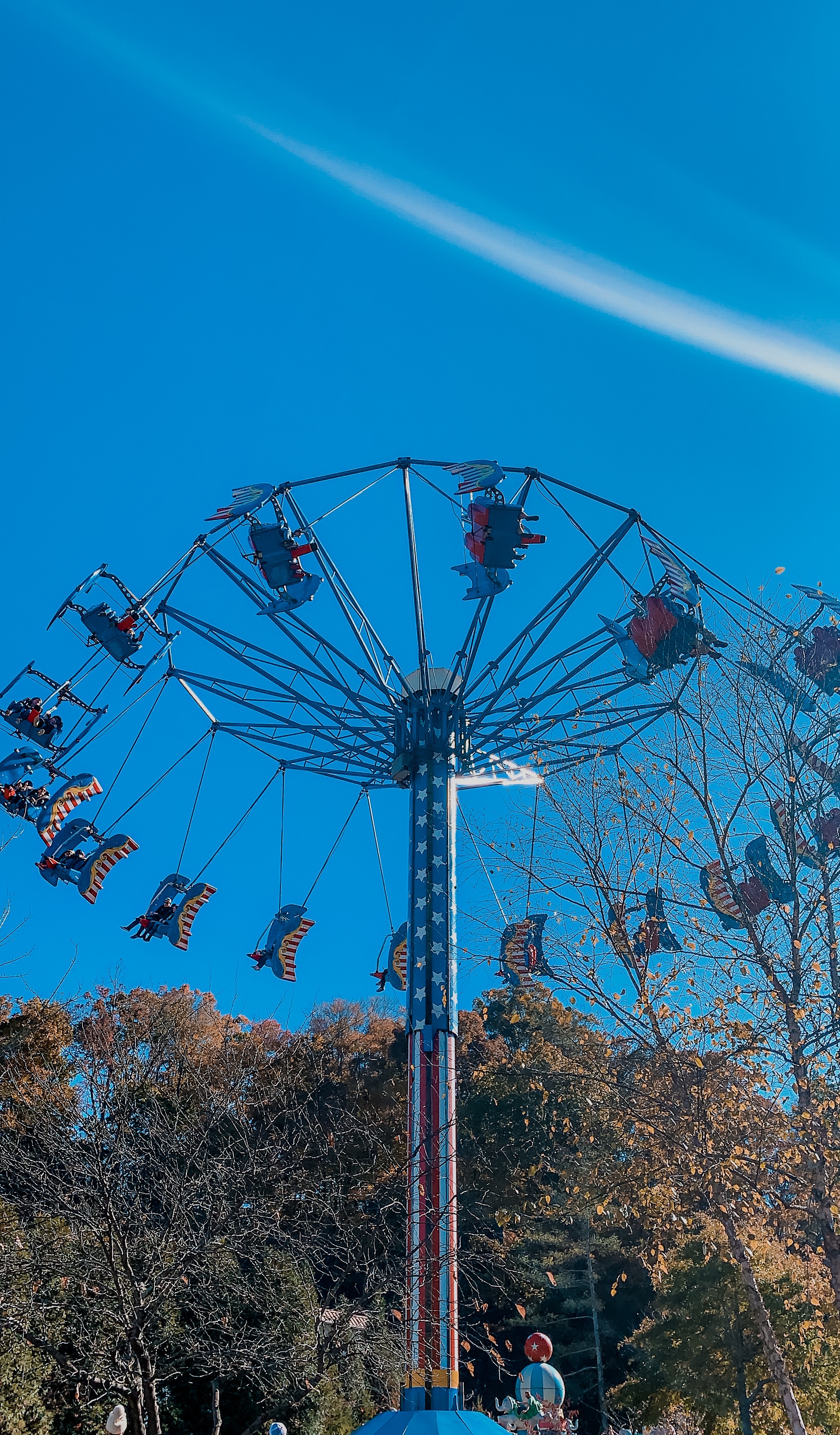 What To Do With A Weekend in Pigeon Forge || Wilderness At The Smokies - Nashville Wifestyles; The Smoky Mountains feel like home. I have spent many weekends in Pigeon Forge since I grew up close to the area in East TN. We went on school trips to Dollywood, my family rented cabins and I have many milestone moments there with Matt and the girls. How had I never been to Wilderness at the Smokies? I remember before I had children of my own hearing my friends talk about how amazing it was and how much fun their kids had. I had so much planned like driving to Gatlinburg. | What To Do With A Weekend in Pigeon Forge || Wilderness At The Smokies by popular travel blog, Nashville Wifestyles: image of a ride at Dollywood.