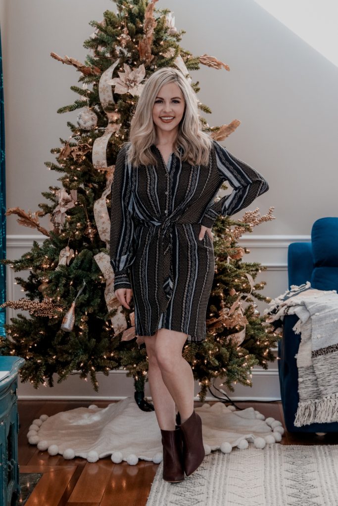 Vici Fall Fashion || Nashville's Newest Clothing Obsession - Nashville Wifestyles; Vici Fall Fashion, Nashville's Newest Clothing Obsession! Vici has a new Nashville store! I’m sure you've seen Vici on Insta. Click to see the star sweater & cute wrap dress looks you can wear this holiday. You can even consider this article a holiday lookbook to inspire your holiday party outfits. Find out how I style red skirts & dresses with sneakers! There's nothing cuter than ripped jeans & cute knit sweaters for women in their 30s. Awesome fashion looks you'll love! |  Vici Nashville Fall Fashion || Nashville's Newest Clothing Obsession by popular Nashville fashion blog, Nashville Wifestyles: image of a woman wearing a Vici Nashville ZELLA BUTTON DOWN TIE FRONT SHIRT DRESS and Vici Nashville CAPITOL HILL FAUX LEATHER HEELED BOOTIE.
