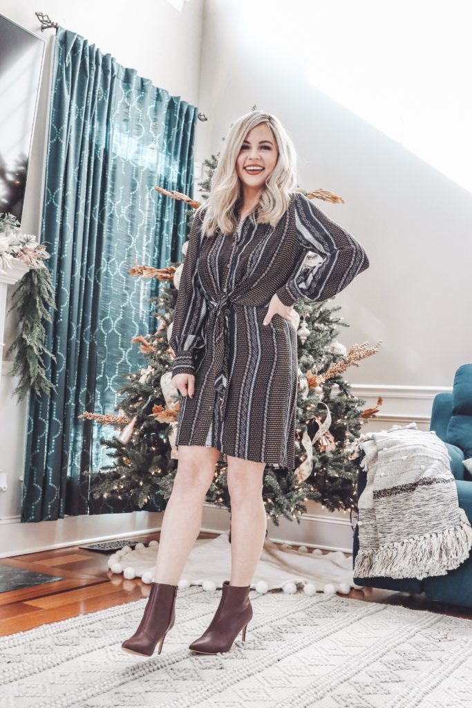 Vici Fall Fashion || Nashville's Newest Clothing Obsession - Nashville Wifestyles; Vici Fall Fashion, Nashville's Newest Clothing Obsession! Vici has a new Nashville store! I’m sure you've seen Vici on Insta. Click to see the star sweater & cute wrap dress looks you can wear this holiday. You can even consider this article a holiday lookbook to inspire your holiday party outfits. Find out how I style red skirts & dresses with sneakers! There's nothing cuter than ripped jeans & cute knit sweaters for women in their 30s. Awesome fashion looks you'll love! | Vici Nashville Fall Fashion || Nashville's Newest Clothing Obsession by popular Nashville fashion blog, Nashville Wifestyles: image of a woman wearing a Vici Nashville ZELLA BUTTON DOWN TIE FRONT SHIRT DRESS and Vici Nashville CAPITOL HILL FAUX LEATHER HEELED BOOTIE.