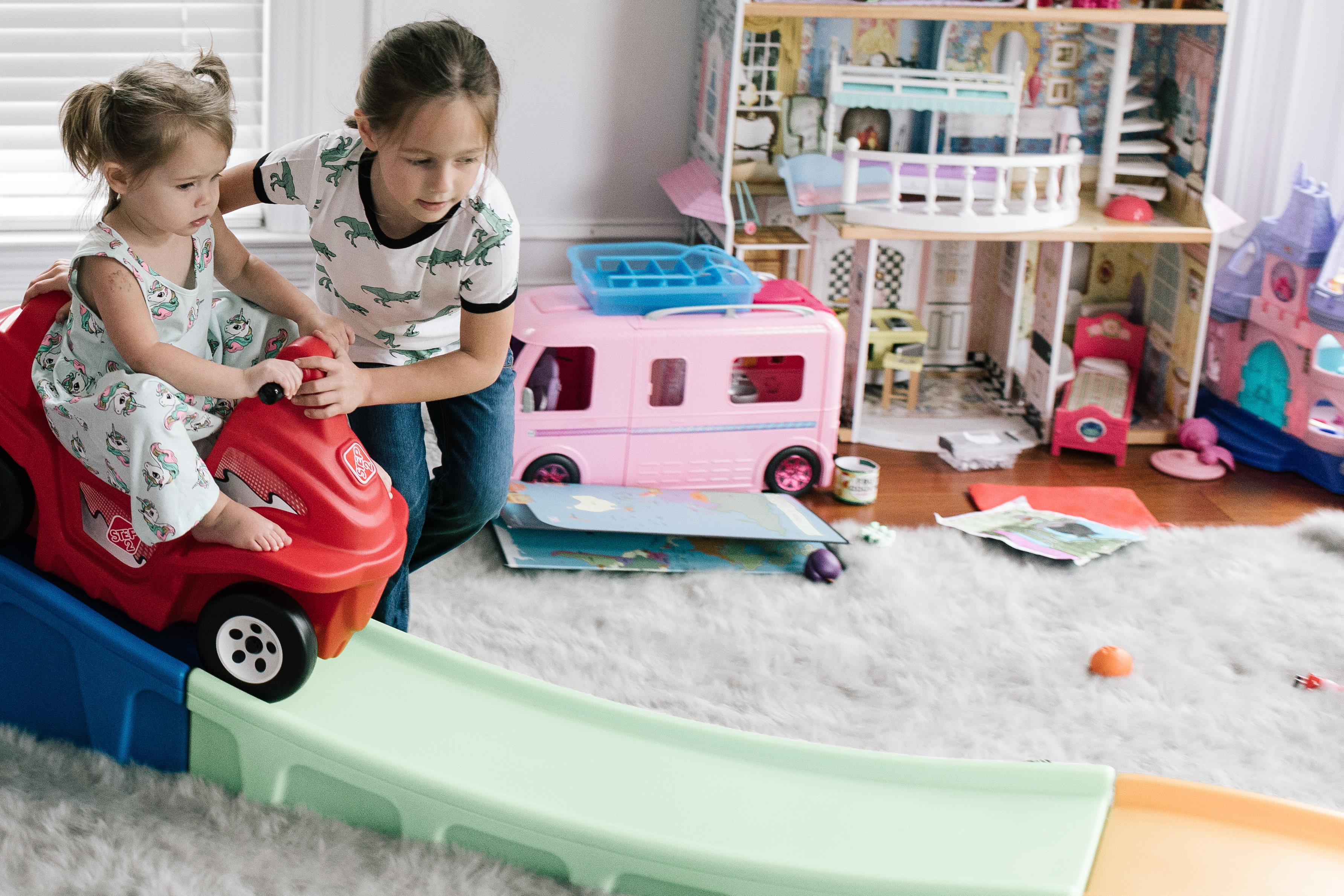 Best Christmas Gifts For Kids - Nashville Wifestyles; Christmas is approaching fast! I am on my A game this year. With my kids being 4.5 years apart it can be tricky when buying their presents because they are at such different age brackets. I’m sure you guys can relate to the struggle of figuring out what to buy your kids each Christmas, so I’m here to offer any guidance I can. Luckily in addition to the amazing prices Walmart and Target already have when you sign up for the Ibotta app you can also get rewarded when you spend. | Best Gifts For Kids by popular Nashville life and style blog, Nashville Wifestyles: image of two girls playing in a room full of toys.