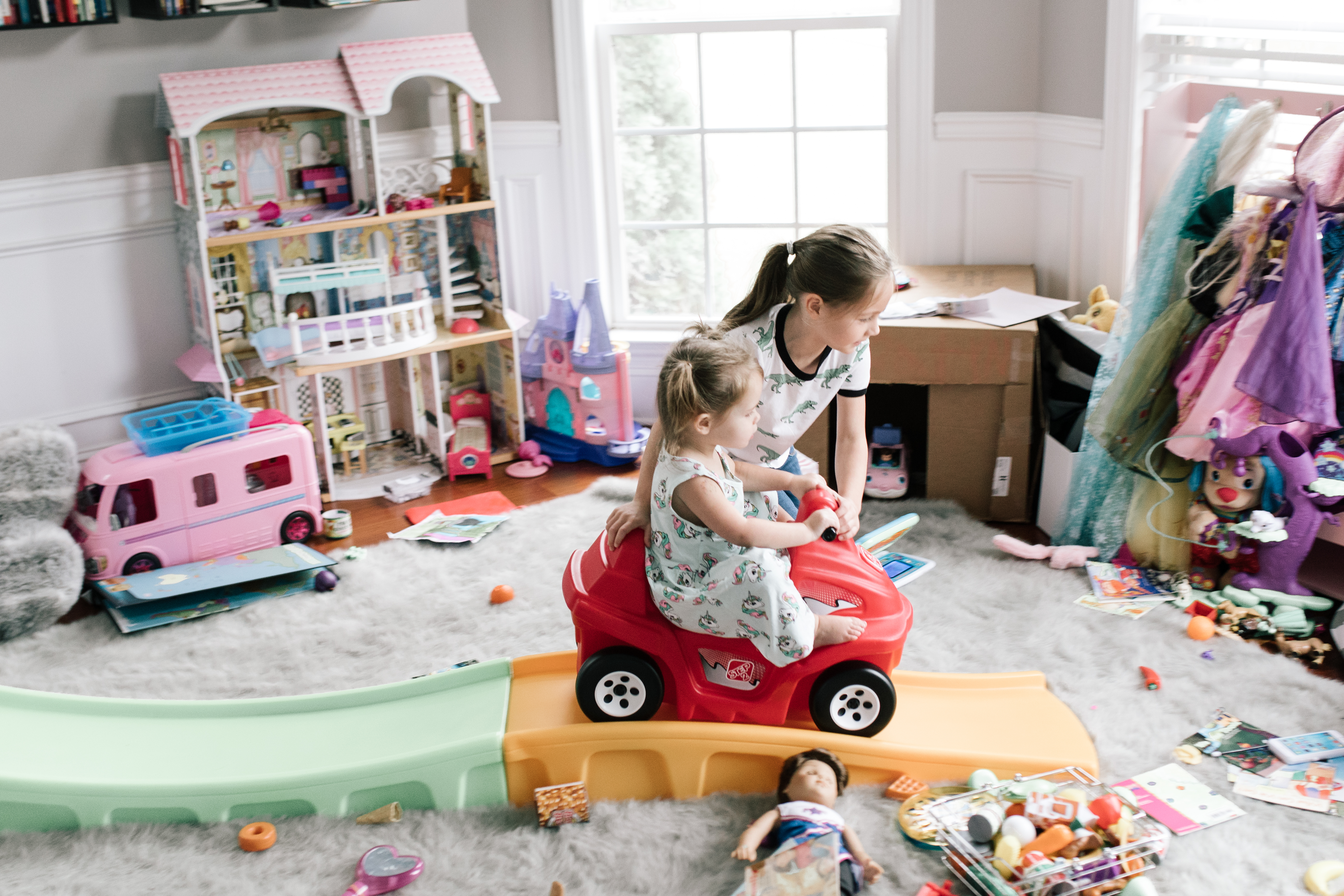 Best Christmas Gifts For Kids - Nashville Wifestyles; Christmas is approaching fast! I am on my A game this year. With my kids being 4.5 years apart it can be tricky when buying their presents because they are at such different age brackets. I’m sure you guys can relate to the struggle of figuring out what to buy your kids each Christmas, so I’m here to offer any guidance I can. Luckily in addition to the amazing prices Walmart and Target already have when you sign up for the Ibotta app you can also get rewarded when you spend. | Best Gifts For Kids by popular Nashville life and style blog, Nashville Wifestyles: image of two girls playing in a room full of toys.
