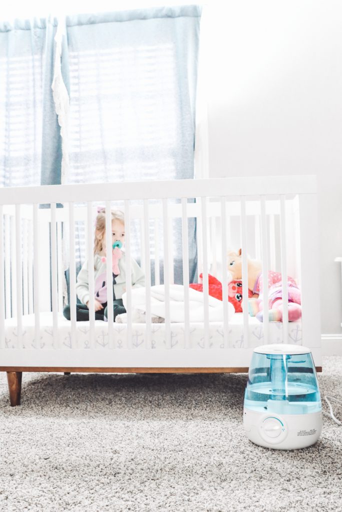 Soothe Coughs & Sore Throats with Vick's Filter Free Cool Mist Humidifier by popular Nashville life and style blog, Nashville Wifestyles: image of a Vick's filter free cool mist humidifier next to a baby crib. 