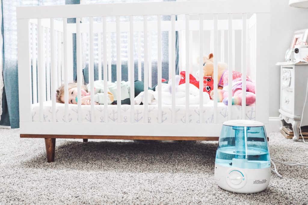 Soothe Coughs & Sore Throats with Vick's Filter Free Cool Mist Humidifier by popular Nashville life and style blog, Nashville Wifestyles: image of a Vick's filter free cool mist humidifier next to a baby crib. 