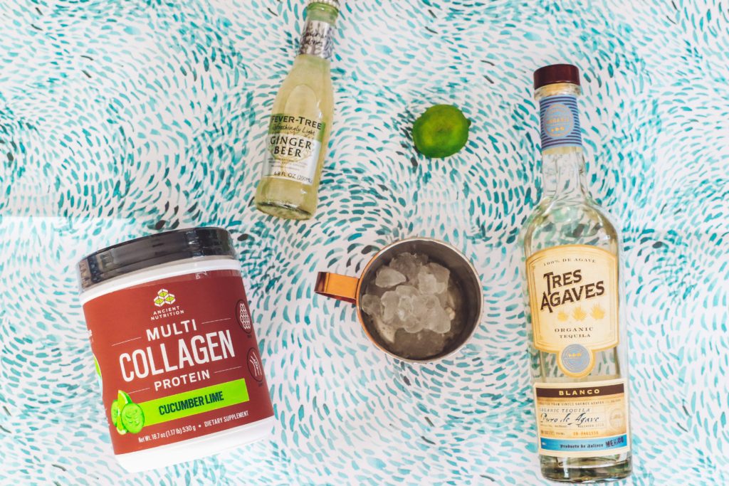 Cucumber Lime Mexican Mule Recipe || Collagen Cocktail by popular Nashville life and style blog, Nashville Wifestyles: image of Tres Agaves and Ancient Nutrition multi Collagen Protein powder a copper mug, and a lime wedge.