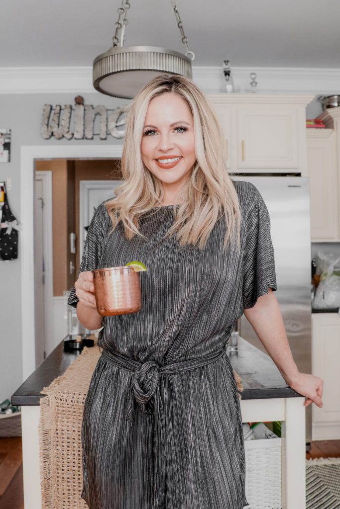 Cucumber Lime Mexican Mule Recipe || Collagen Cocktail by popular Nashville life and style blog, Nashville Wifestyles: image of a woman holding a copper mug with a Mexican Mule cocktail. 