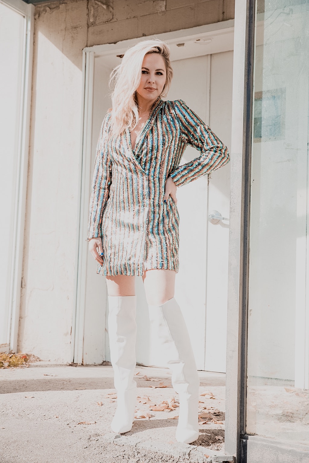 Rocking the Blazer Dress trend by popular Nashville fashion blog, Nashville Wifestyles: image of a woman wearing a sequin blazer dress and over-the-knee white boots.