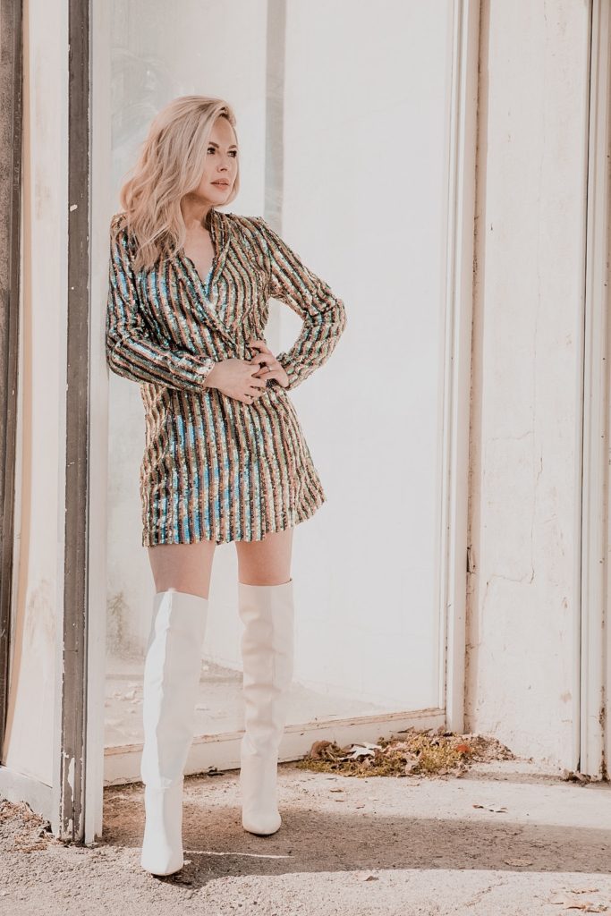 Rocking the Blazer Dress trend by popular Nashville fashion blog, Nashville Wifestyles: image of a woman wearing a sequin blazer dress and over-the-knee white boots.
