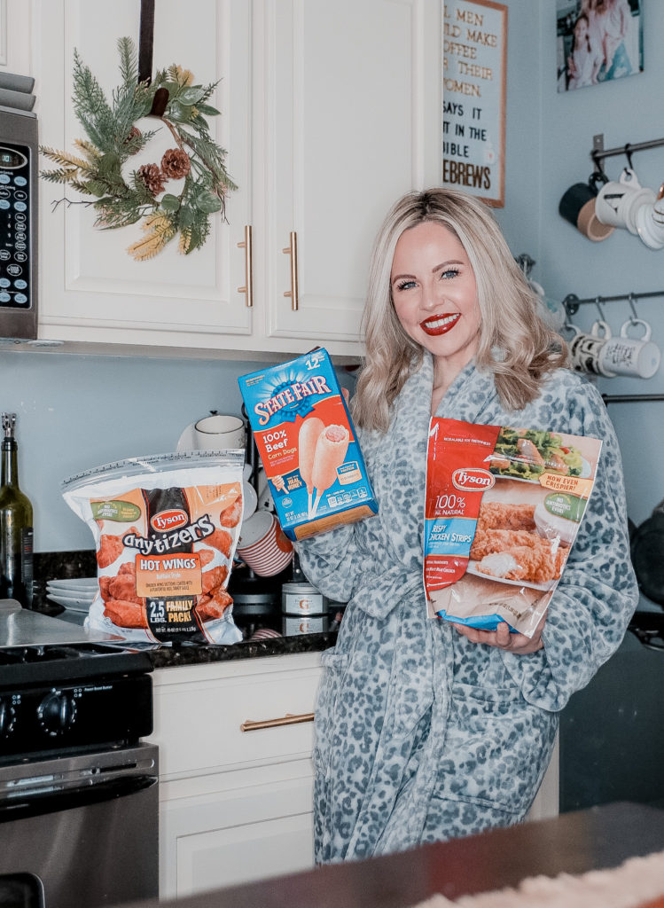 Easy Game Day Entertaining In Less Than 30 Minutes by popular Nashville lifestyle blog, Nashville Wifestyles: image of a woman holding various Tyson frozen food products. 