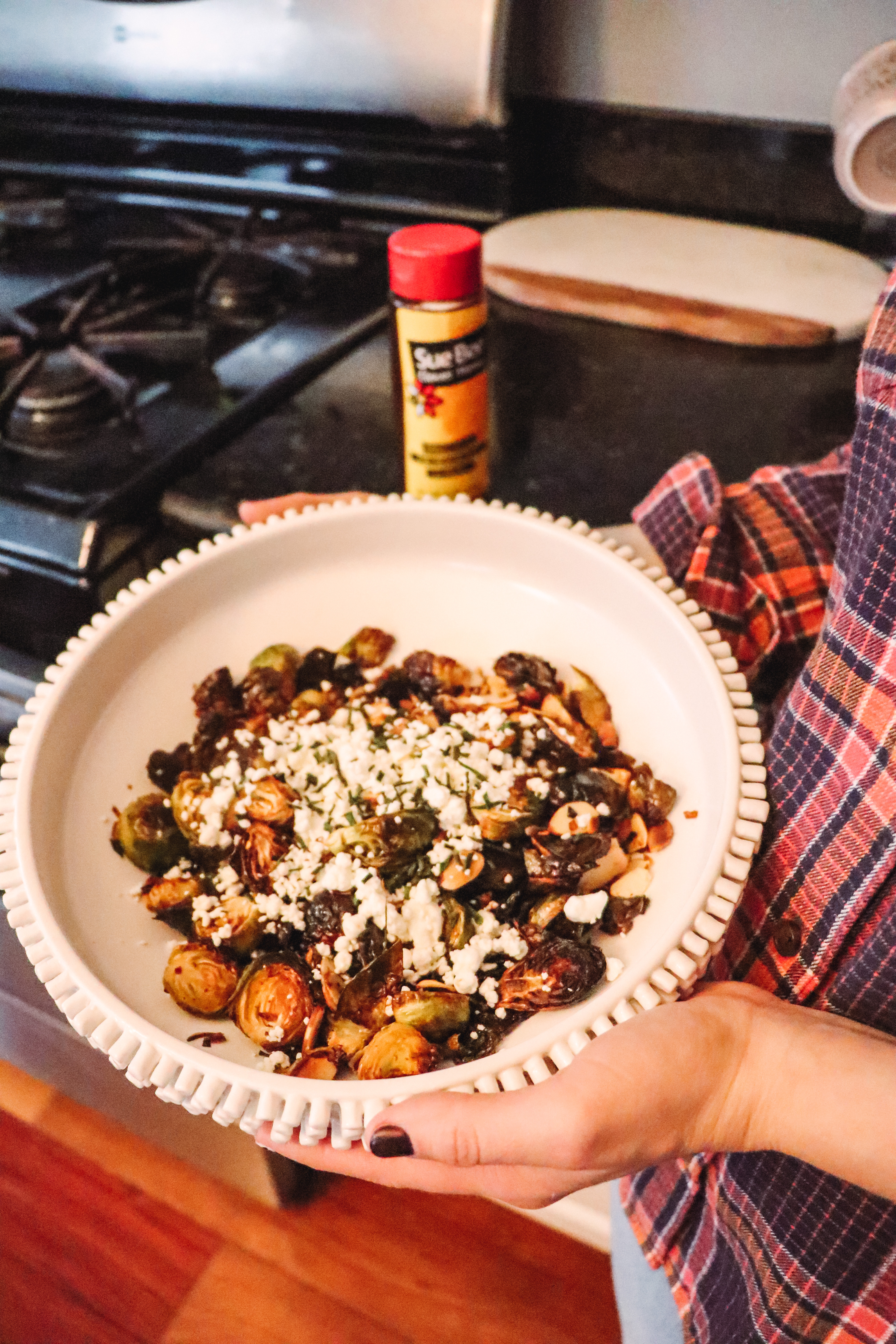 Honey Roasted Brussel Sprouts by popular Nashville life and style blog, Nashville Wifestyles: image of a white ceramic bowl containing honey roasted Brussel sprouts.