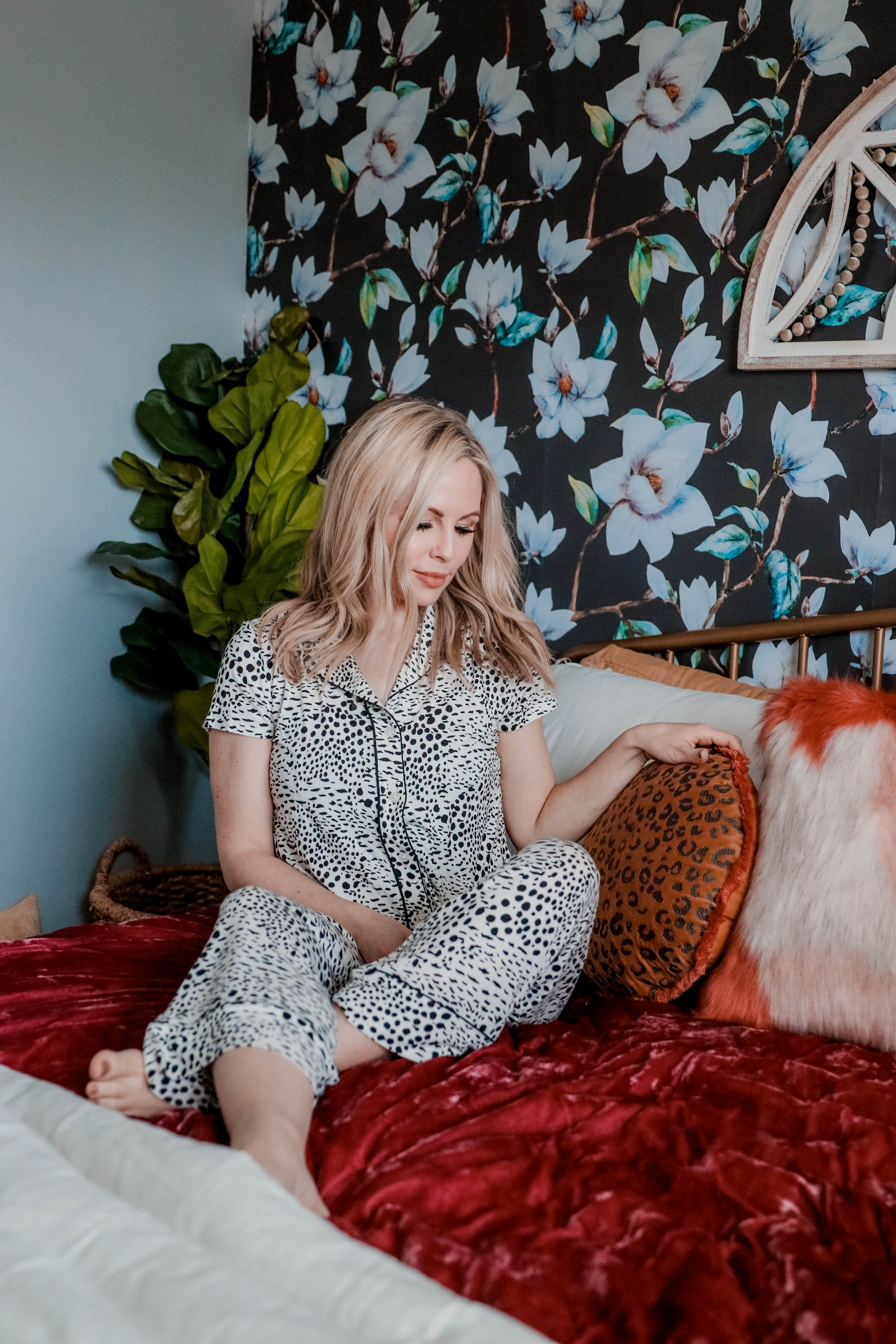 Best Loungewear by popular Nashville fashion blog, Nashville Wifestyles: image of a woman sitting on a bed and wearing leopard print pajamas.